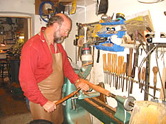 Chris McNeilly moulding a pipe on his lathe